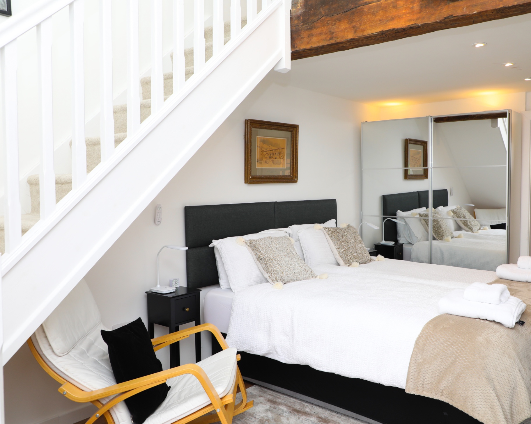 Main sleeping area under the white staircase